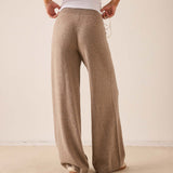 Beige wide-leg cashmere pants with a soft knit finish.