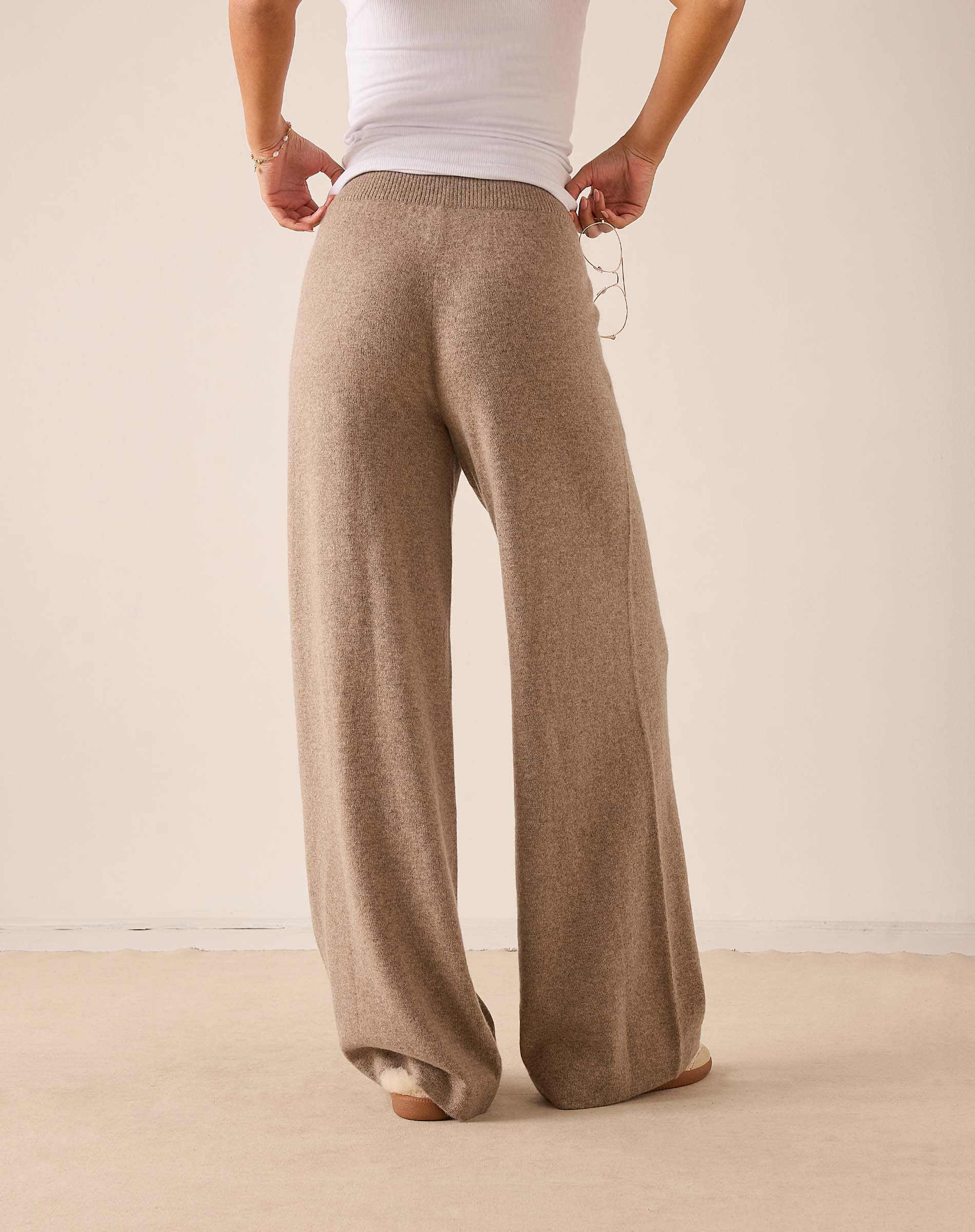 Beige wide-leg cashmere pants with a soft knit finish.