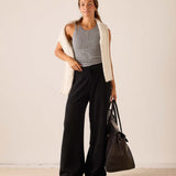Black wide-leg cashmere pants with a relaxed fit and flowing silhouette.