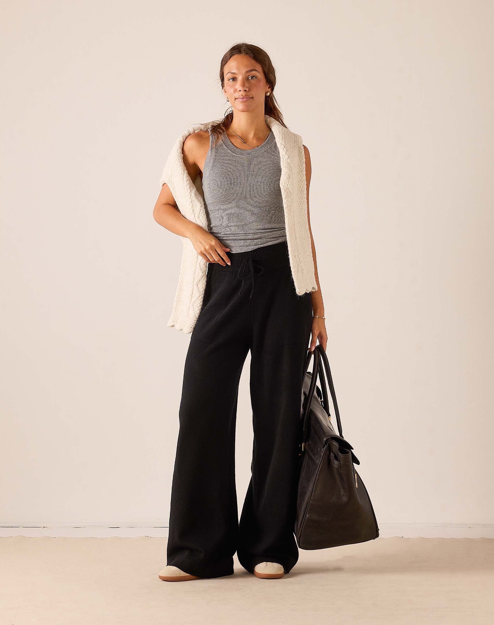 Black wide-leg cashmere pants with a relaxed fit and flowing silhouette.