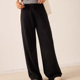 Black wide-leg cashmere pants with a drawstring waist