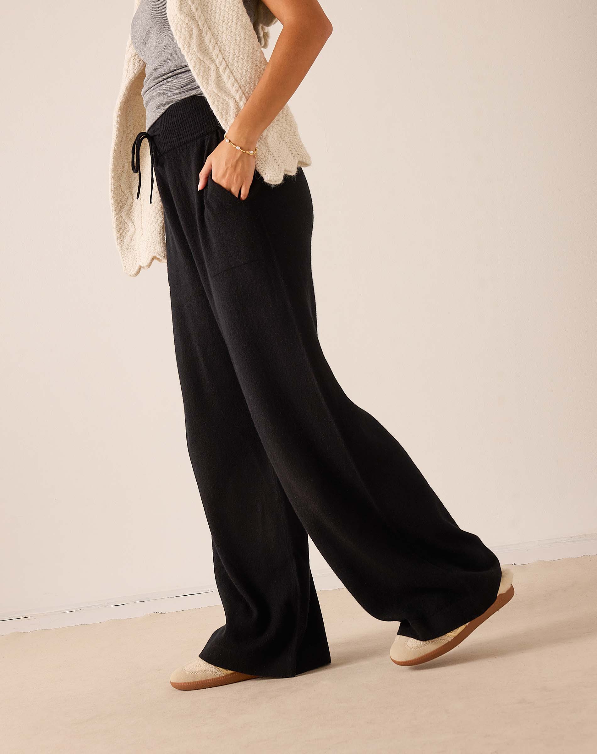 Black wide-leg cashmere pants with a drawstring waist.