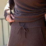 Mocha brown cashmere wide leg pants with a drawstring waist and ribbed hem.
