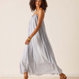 Woman wearing a light blue dress against a plain background