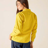 Woman wearing a yellow jacket on a beige background