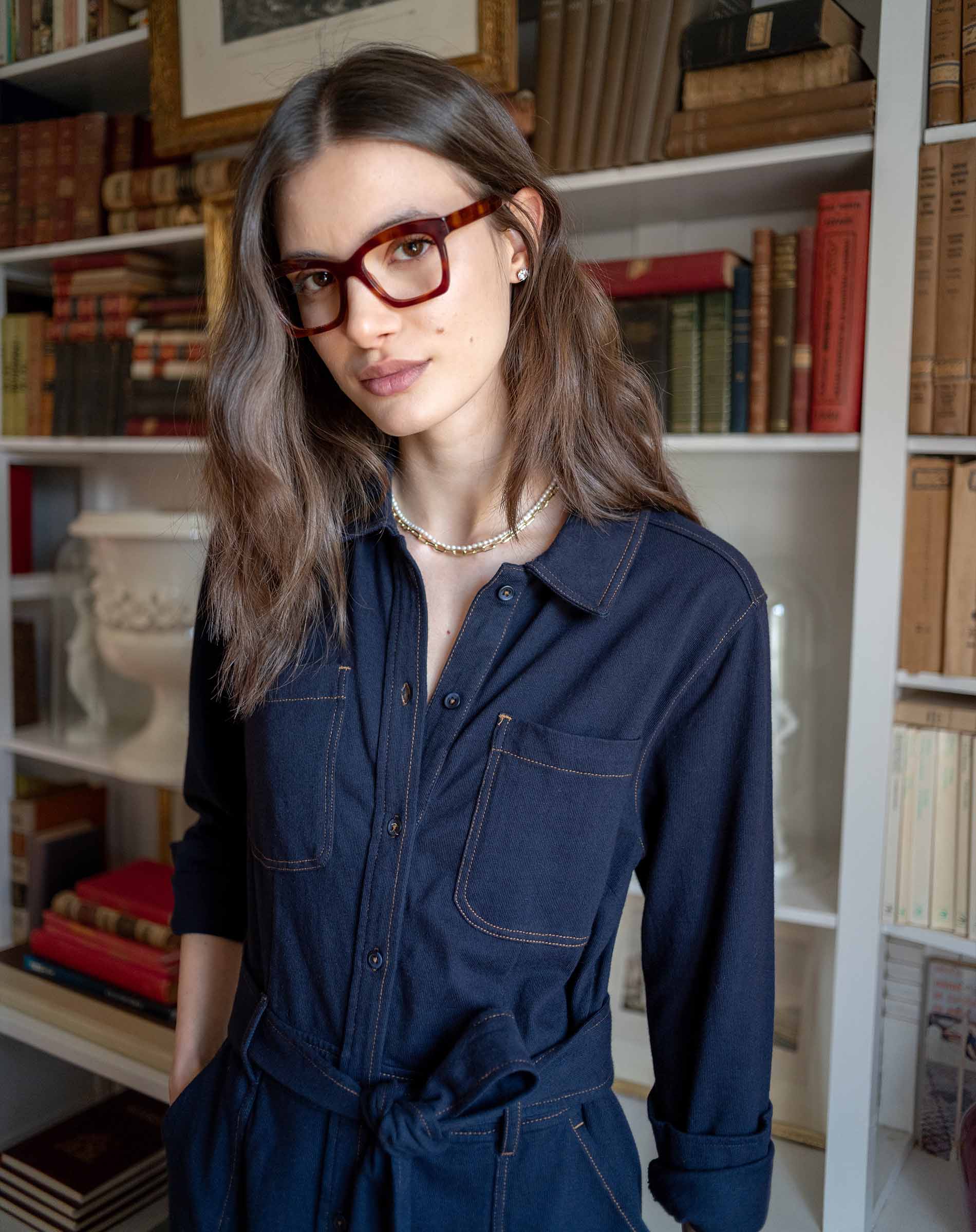 Women's travel-friendly navy blue button-front utility dress with a belted waist and chest pockets.