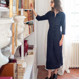 Navy blue utility style button-down midi dress with long sleeves and chest pockets.