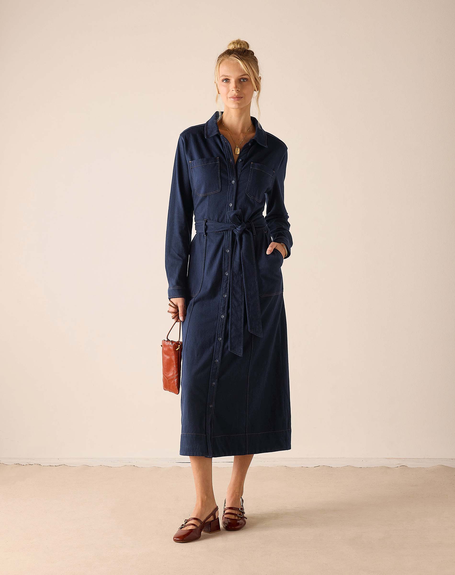 Navy blue button-front maxi dress with a waist tie and functional pockets.