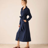 Navy blue utility dress with a wrap-around waist tie and long sleeves.