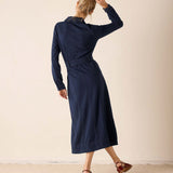 Navy blue textured button-down utility dress featuring a defined waistline and long sleeves.