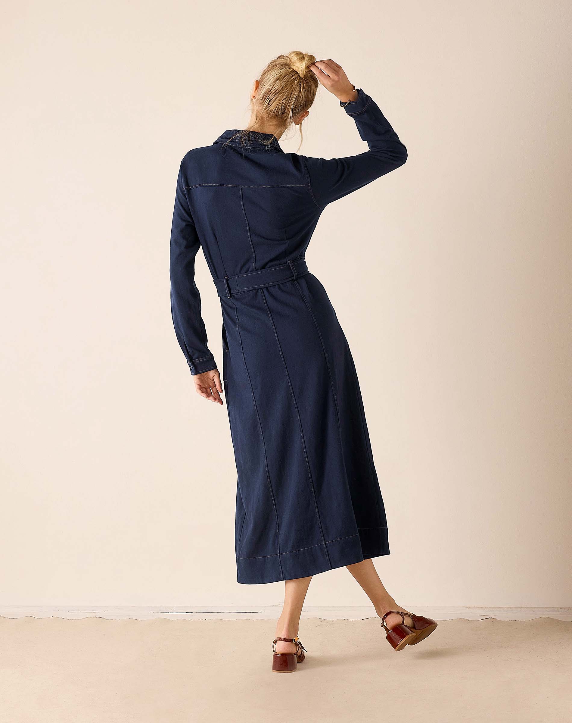 Navy blue textured button-down utility dress featuring a defined waistline and long sleeves.