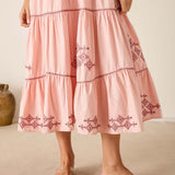 Pink dress with embroidery on a neutral background