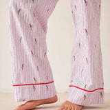 Pink striped pajama pants with red trim on a plain background