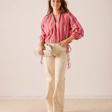 Women's travel-friendly rojo striped poet long-sleeve top with billowy sleeves and a V-neckline.