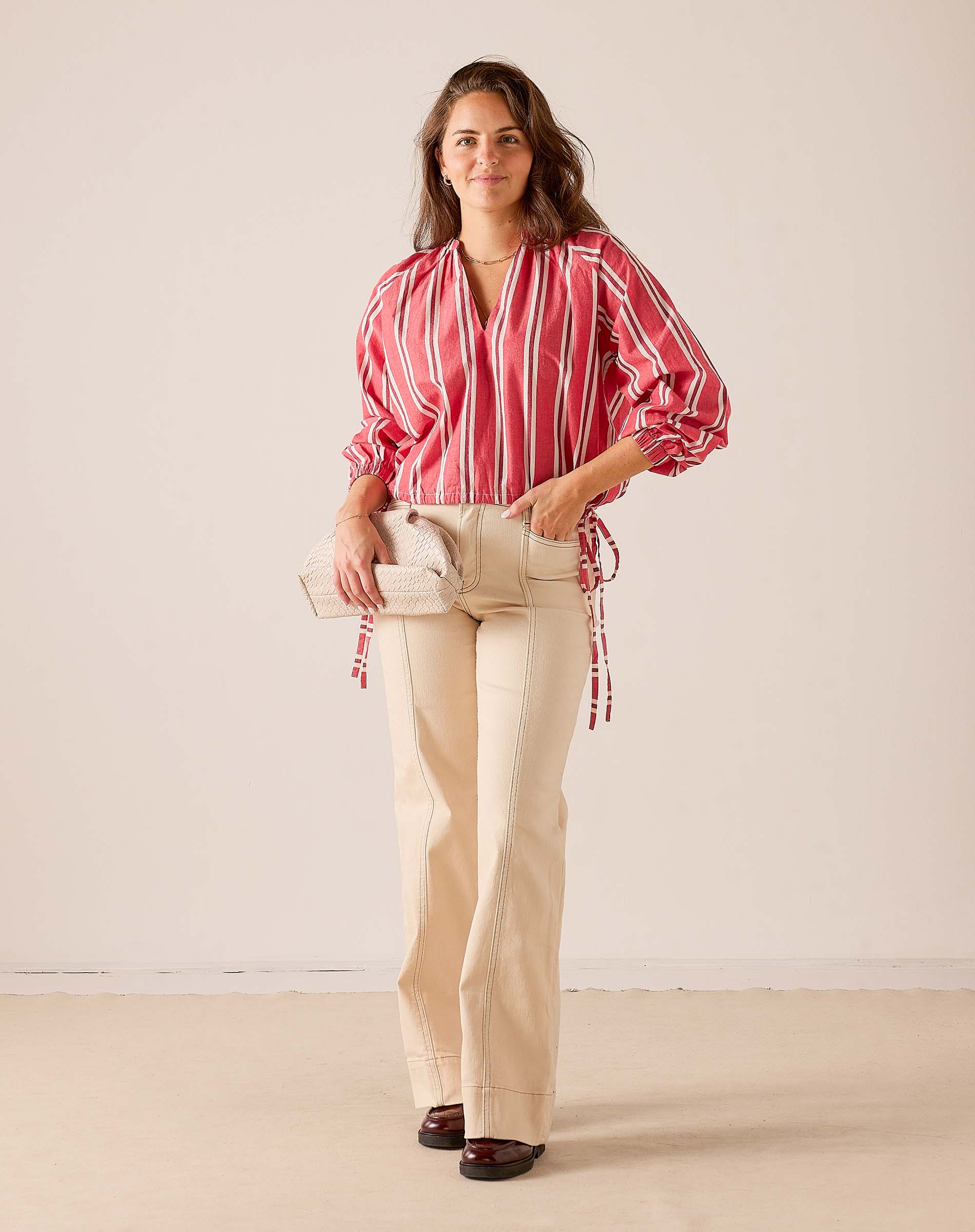 Women's travel-friendly rojo striped poet long-sleeve top with billowy sleeves and a V-neckline.