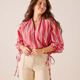 Rojo red and white striped poet-style long sleeve blouse with puff sleeves and tie details.