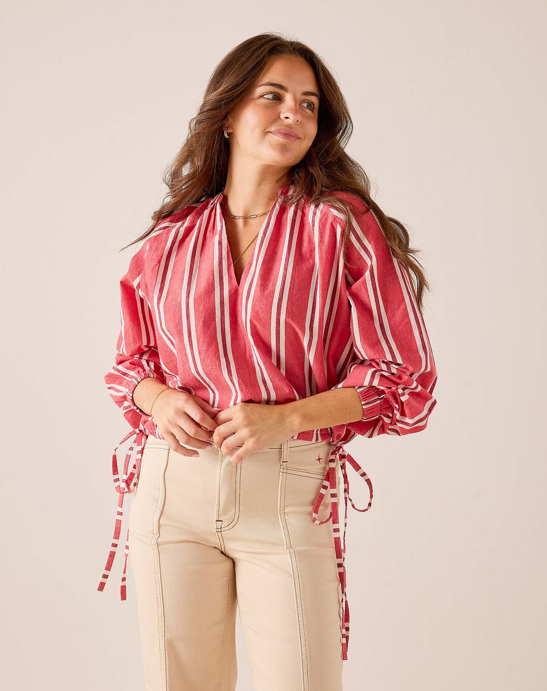 Rojo red and white striped poet-style long sleeve blouse with puff sleeves and tie details.