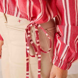 Rojo red and white striped cotton poet top featuring a drawstring waist and puffed sleeves.