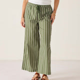 Person wearing green striped pants on a white background