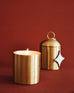 lit Pumpkin Whimsea Brass Candle next to Pumpkin Whimsea Brass Candle with lid on