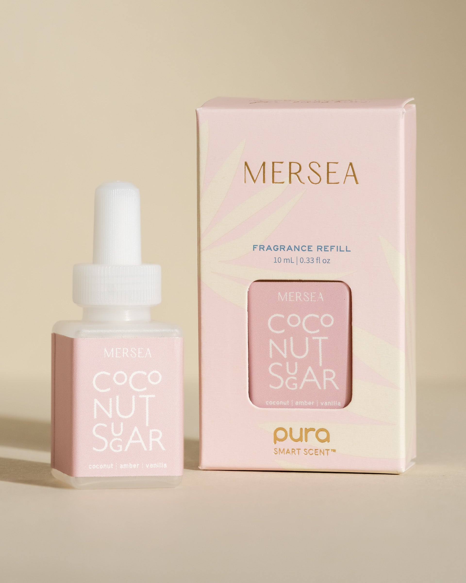 pura smart vial of mersea coconut sugar scent sitting next to boxed version of product