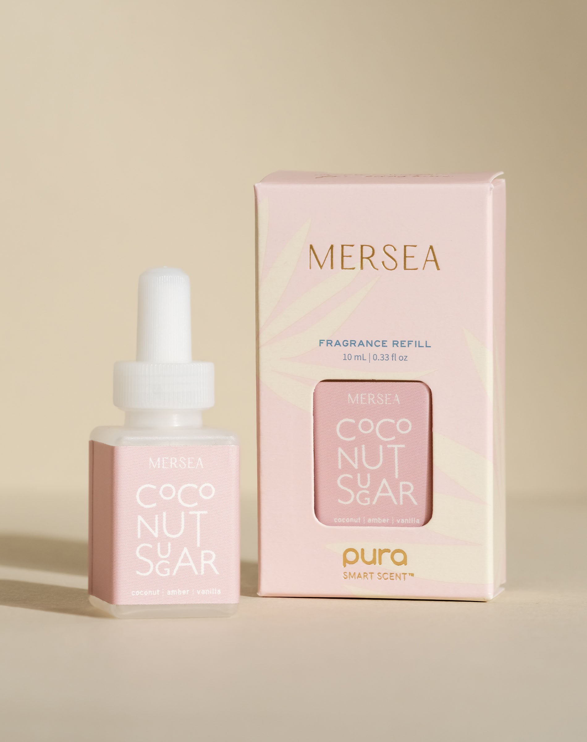 pura smart vial of mersea coconut sugar scent sitting next to boxed version of product