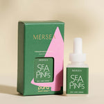 pura smart vial of mersea sea pines scent sitting next to boxed version of same product