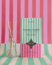 cabana flower reed diffuser on striped backdrop