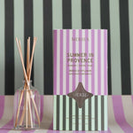 summer in provence reed diffuser with a striped backdrop