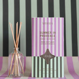 summer in provence reed diffuser with a striped backdrop