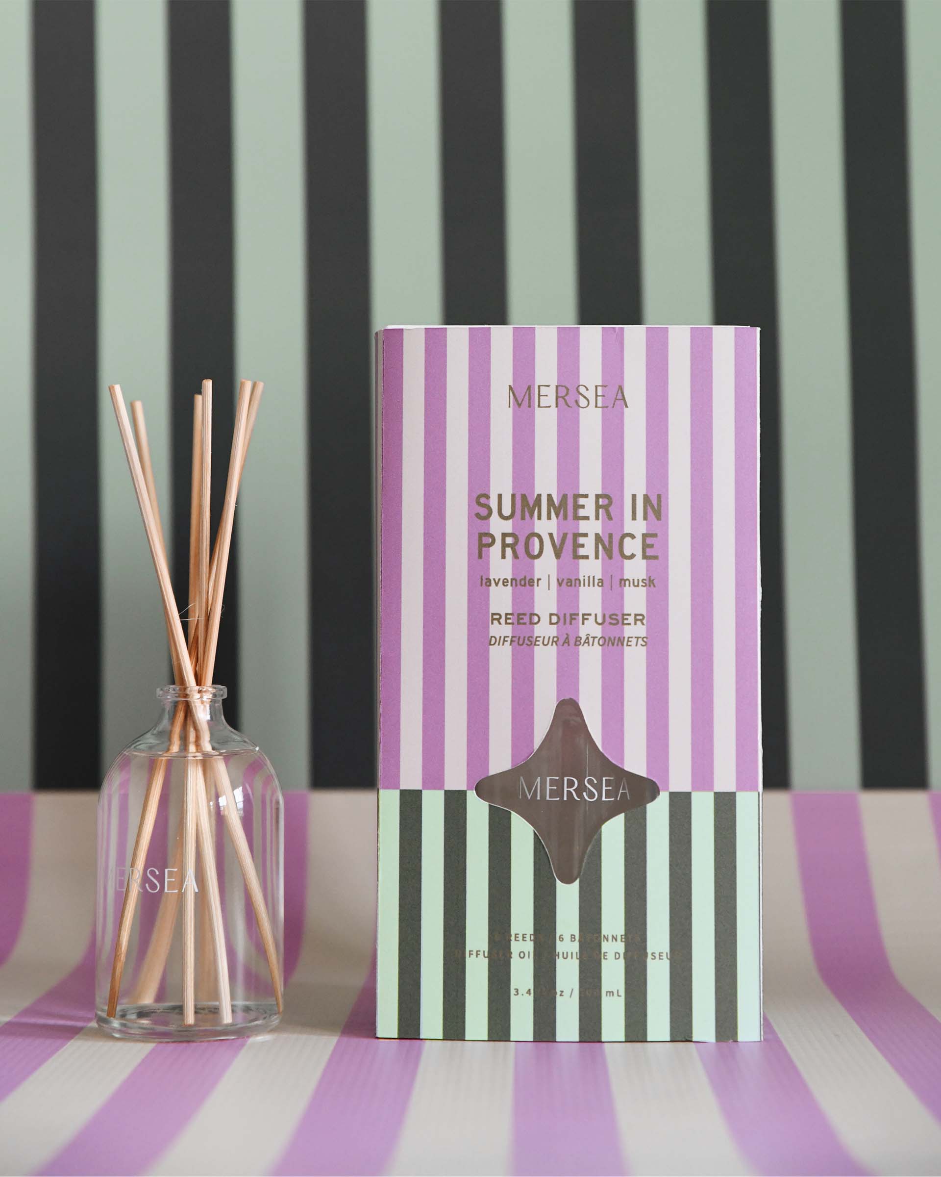summer in provence reed diffuser with a striped backdrop