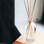 reed diffuser sitting on a book