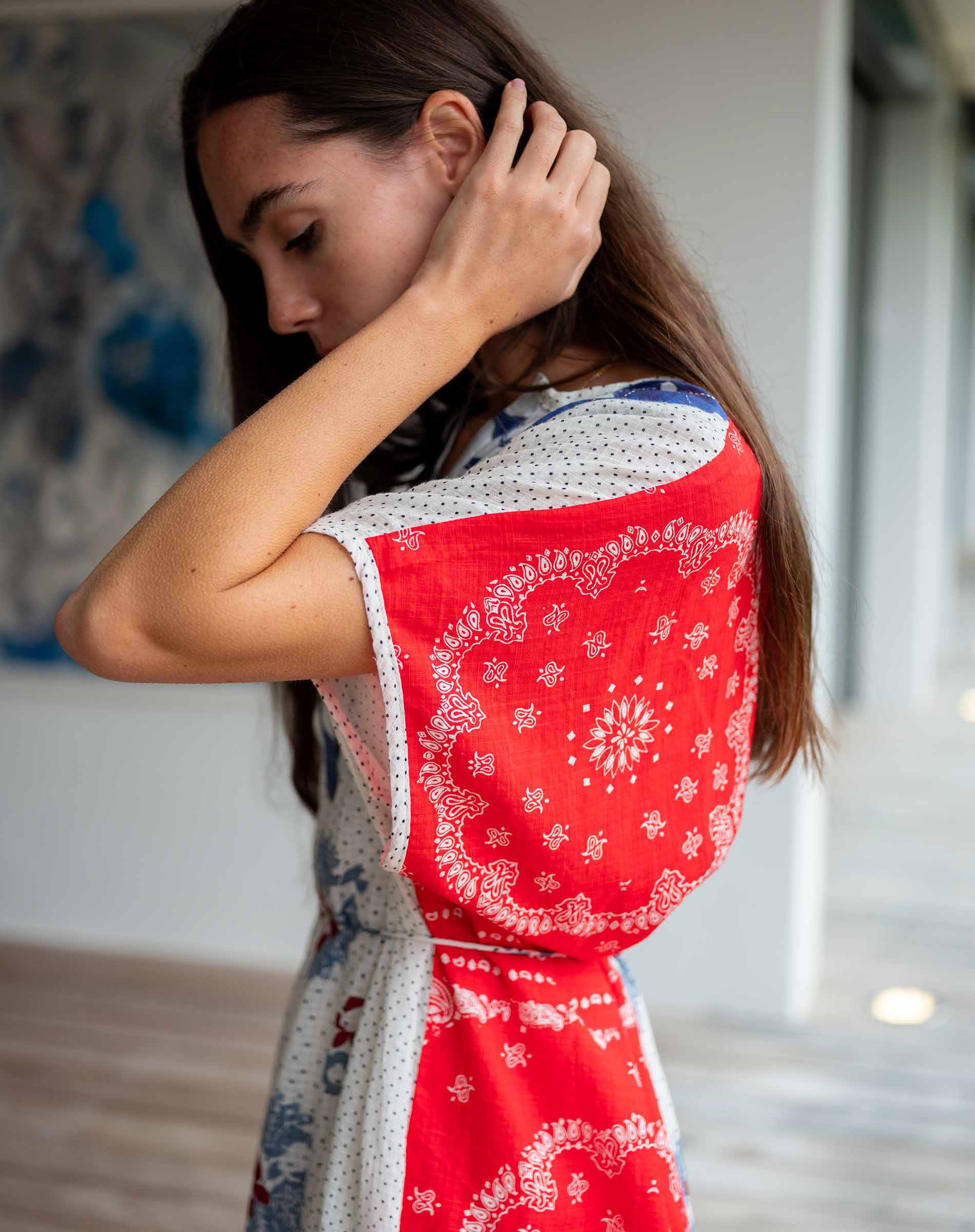 Woman wearing a red and white patterned dress with a blurred background