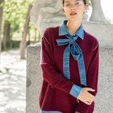 Burgundy boyfriend cashmere sweater featuring a unique oversized denim button-down shirt layered underneath with large statement sleeves.