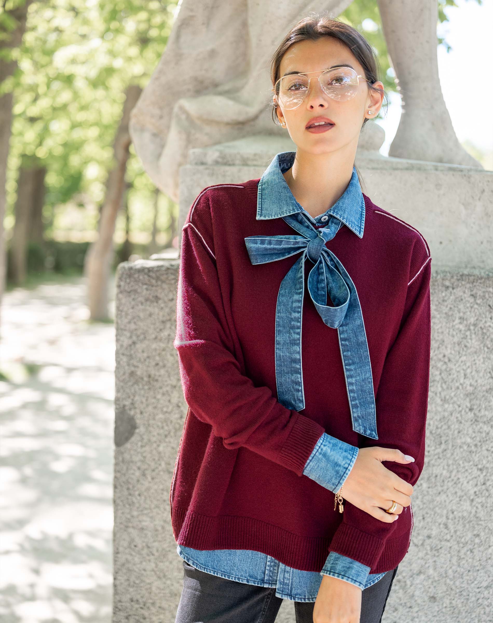 Burgundy boyfriend cashmere sweater featuring a unique oversized denim button-down shirt layered underneath with large statement sleeves.