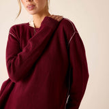 Oversized fit burgundy cashmere knit sweater with contrast stitching and ribbed cuffs.