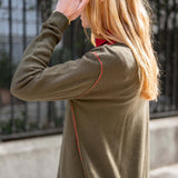 Military green boyfriend cashmere sweater featuring a subtle red stitching detail and soft knit texture.