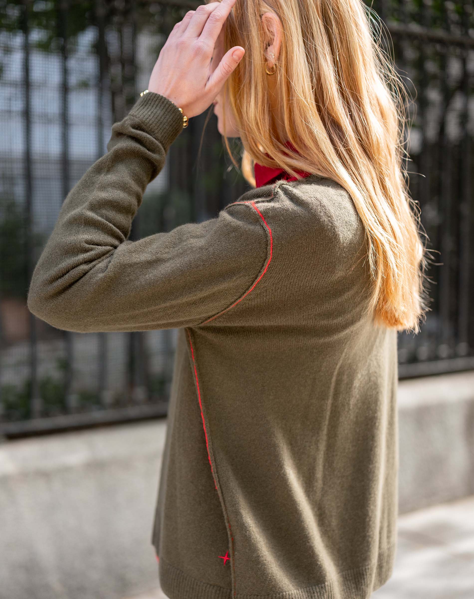 Military green boyfriend cashmere sweater featuring a subtle red stitching detail and soft knit texture.