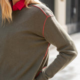 Military green cashmere boyfriend sweater with red piping detail