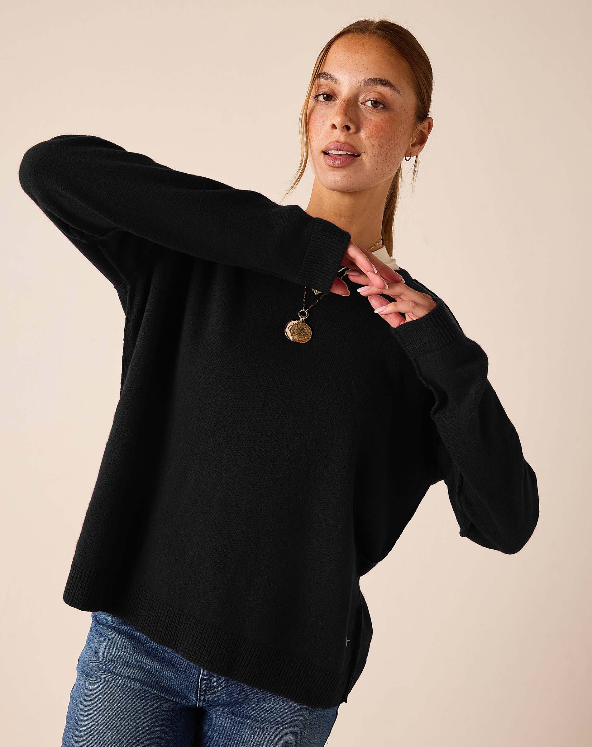 Black relaxed fit knit boyfriend sweater with ribbed cuffs and hem.
