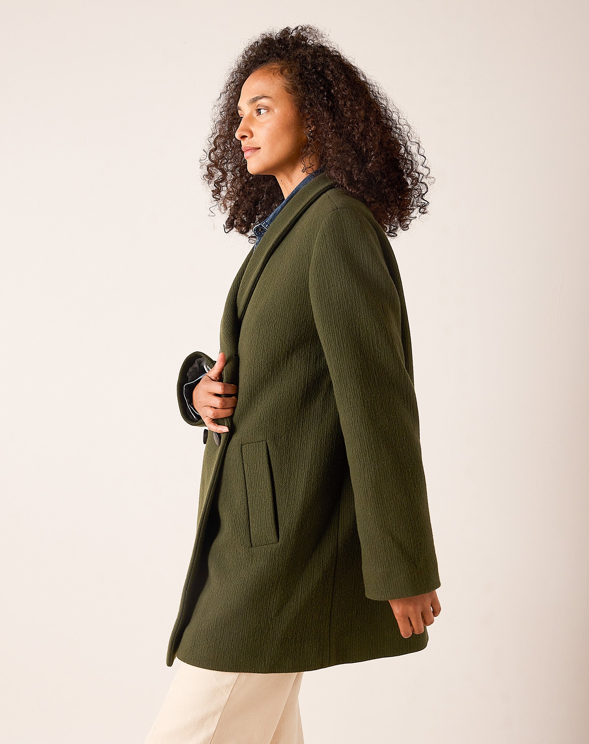 Deep olive tailored wool-blend jacket with a structured collar and front pockets.