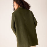 Back view of women's travel-friendly deep olive oversized textured knit jacket with wide sleeves.