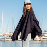 Navy blue ruffled wrap with oversized sleeves and voluminous texture.