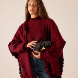 Women's travel-friendly cabernet red knit ruffle wrap with oversized sleeves and a textured finish.