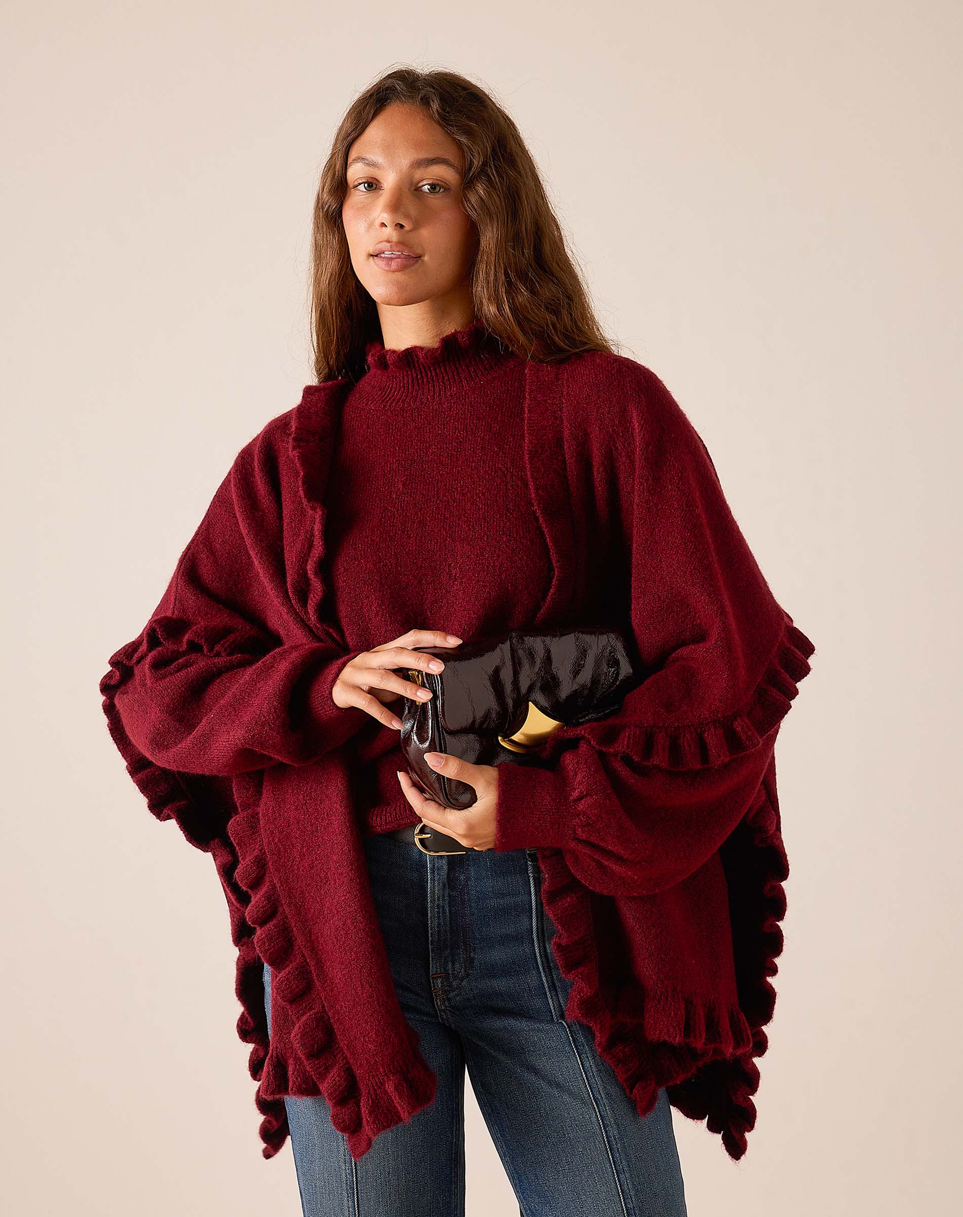 Women's travel-friendly cabernet red knit ruffle wrap with oversized sleeves and a textured finish.