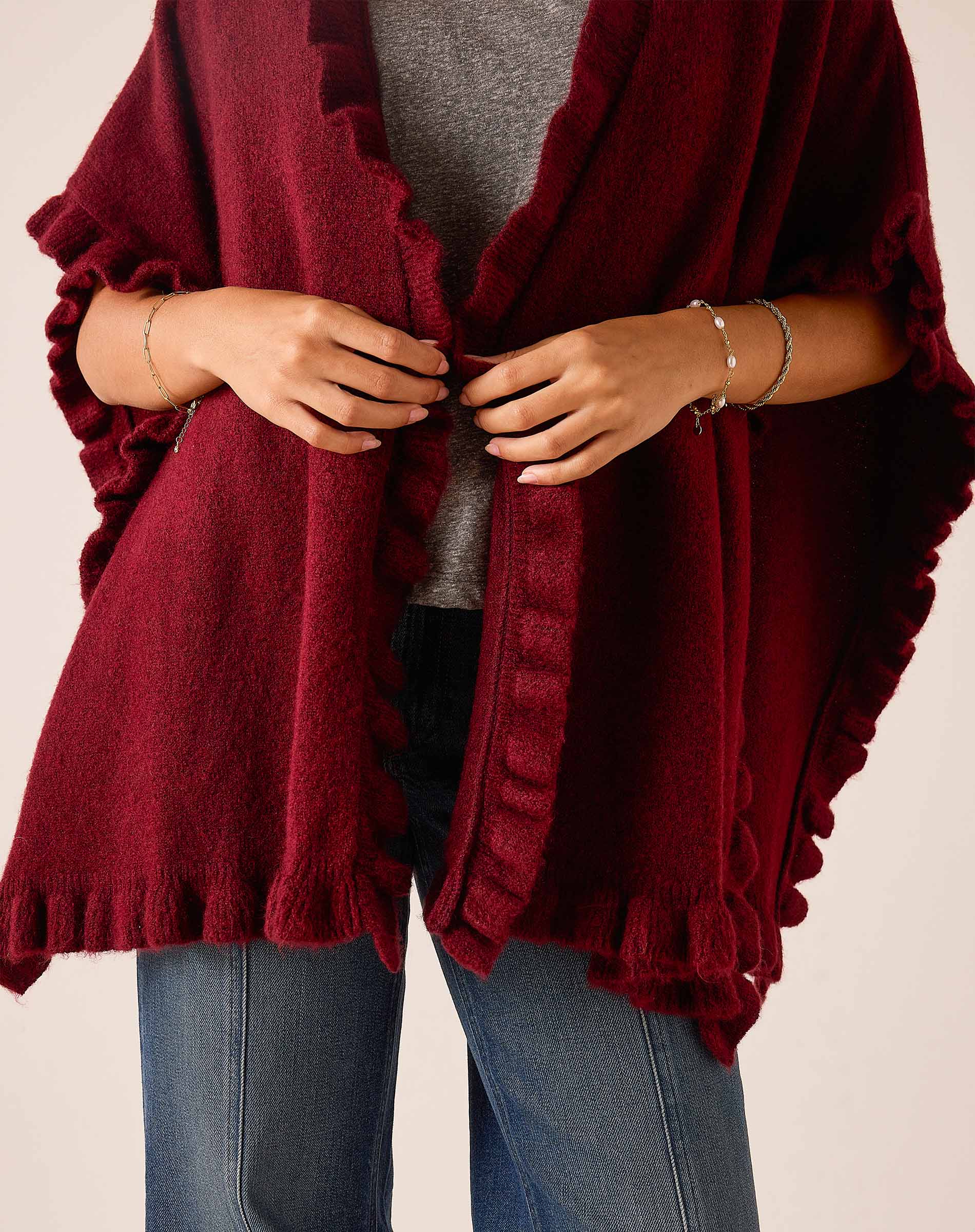 Cabernet red ruffle wrap with a soft knit texture.