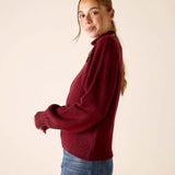 Cabernet red oversized knit sweater with a high neckline and relaxed fit.