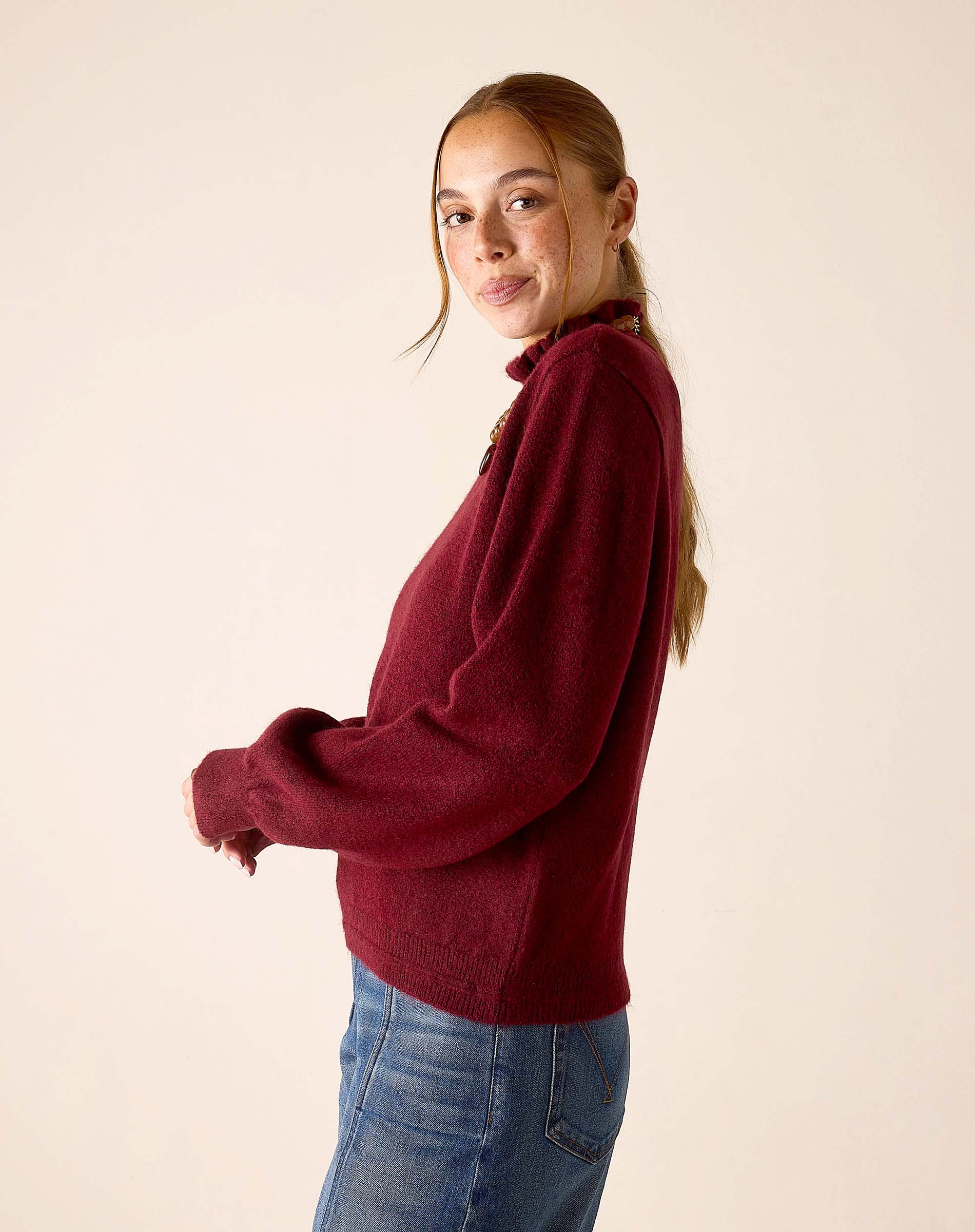 Cabernet red oversized knit sweater with a high neckline and relaxed fit.