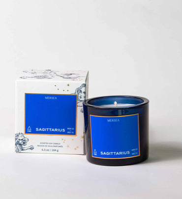 blue sagittarus candle in blue vessel with box on a white background