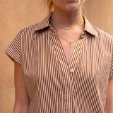 Woman wearing a striped shirt with a neutral background